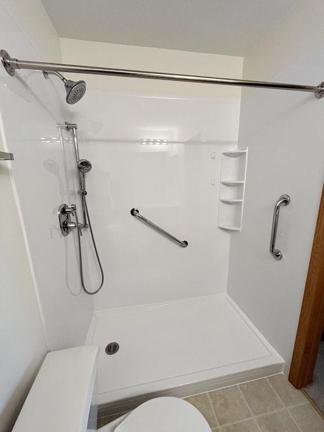 full bath with a stall shower and toilet