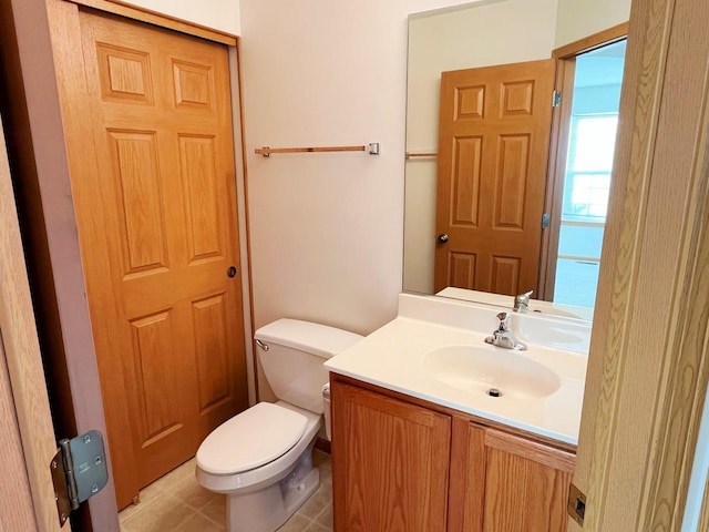 bathroom featuring toilet, tile patterned flooring, and vanity