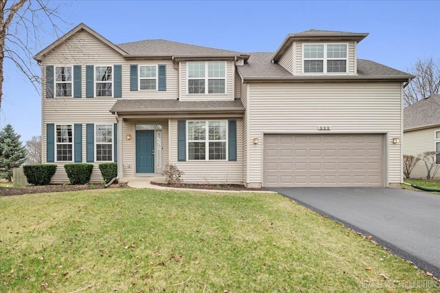 view of front of property with driveway, an attached garage, and a front lawn