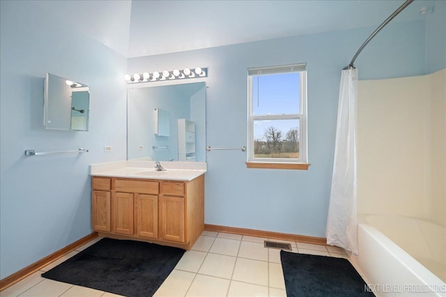 bathroom featuring visible vents, baseboards, tile patterned flooring, and vanity