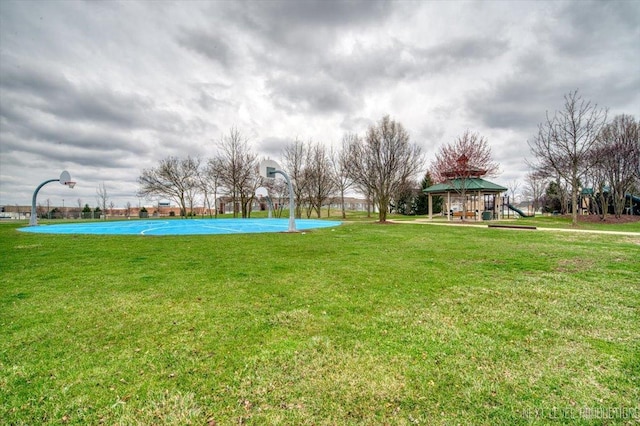 view of yard with a gazebo and community basketball court