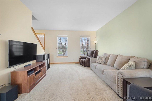 living area with baseboards and light carpet