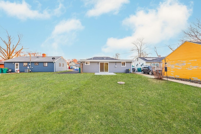rear view of house with a lawn