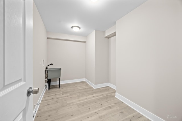 washroom featuring baseboards and light wood-style floors