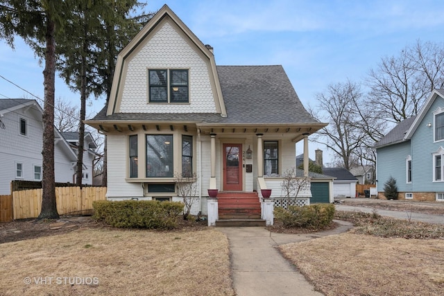 dutch colonial with a gambrel roof, roof with shingles, and fence