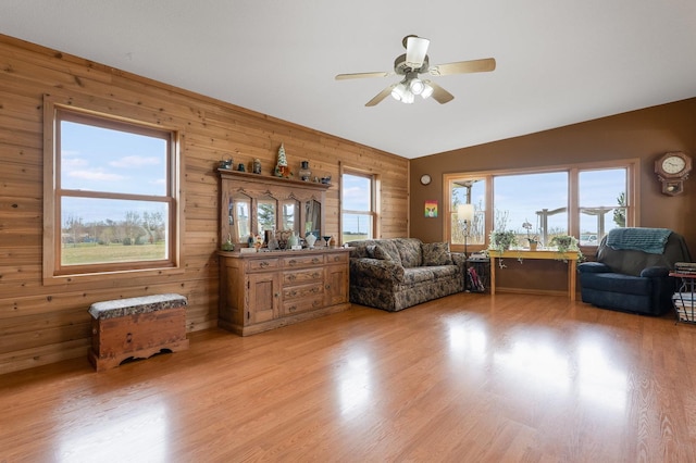 2956 Welland Rd, Earlville, IL 60518 - living room with wooden walls, light wood-style flooring, a ceiling fan, and lofted ceiling