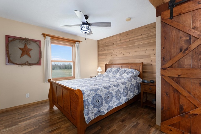 2956 Welland Rd, Earlville, IL 60518 - bedroom featuring dark wood-style flooring, baseboards, ceiling fan, and a barn door