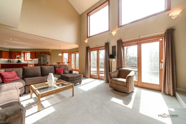 living room with baseboards and light carpet