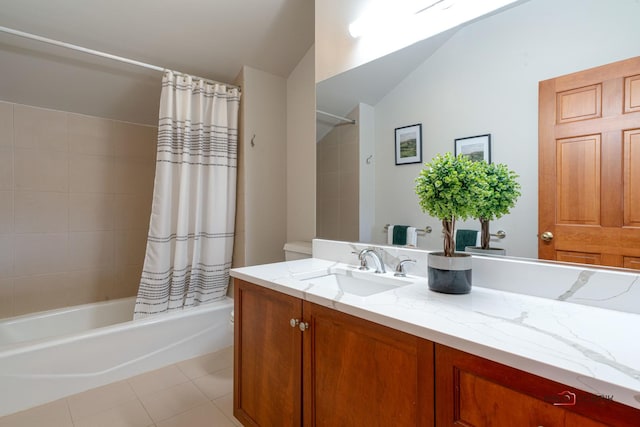 full bathroom with tile patterned floors, shower / bath combo with shower curtain, lofted ceiling, and vanity