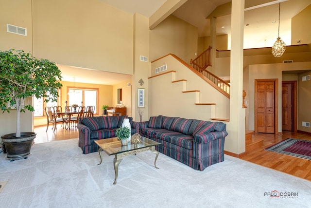 carpeted living room featuring visible vents