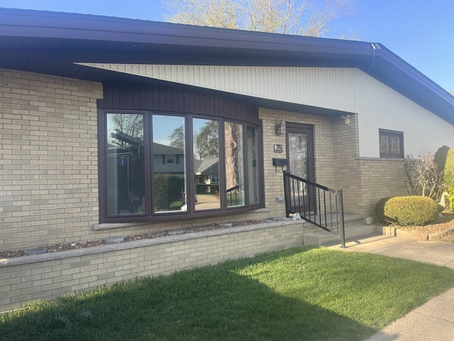 doorway to property featuring brick siding