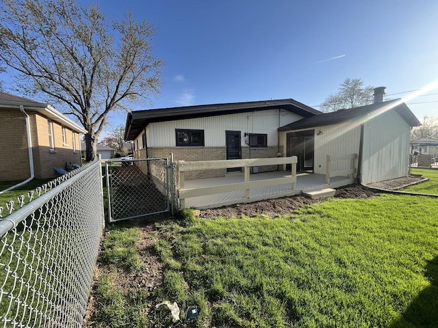 rear view of house featuring brick siding and a gate