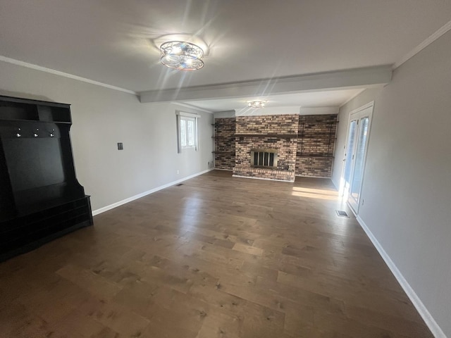 unfurnished living room featuring a brick fireplace, baseboards, wood finished floors, brick wall, and ornamental molding