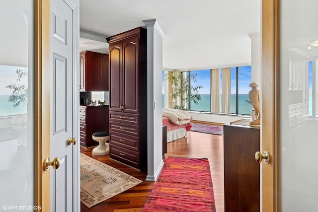 hall featuring wood finished floors and a water view