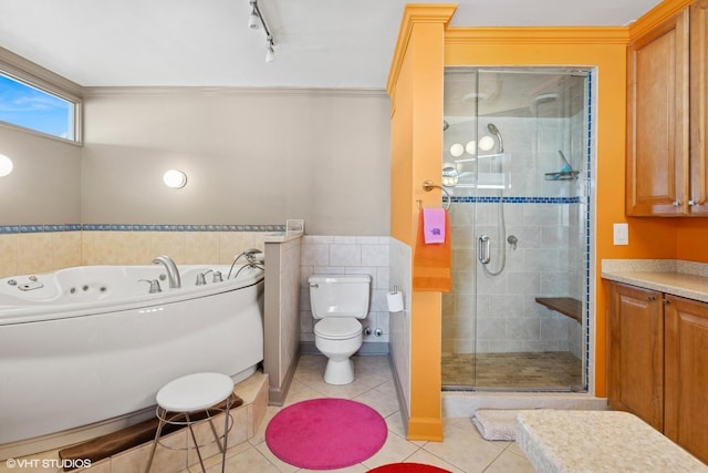 full bath with tile patterned flooring, a shower stall, toilet, a garden tub, and ornamental molding