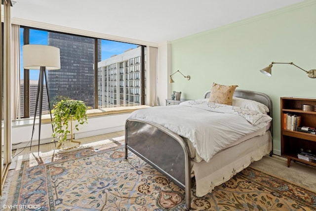 bedroom with multiple windows and crown molding