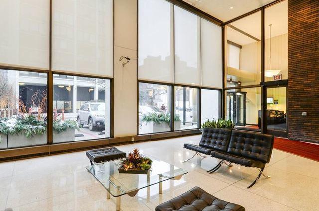 community lobby featuring a high ceiling and a wall of windows