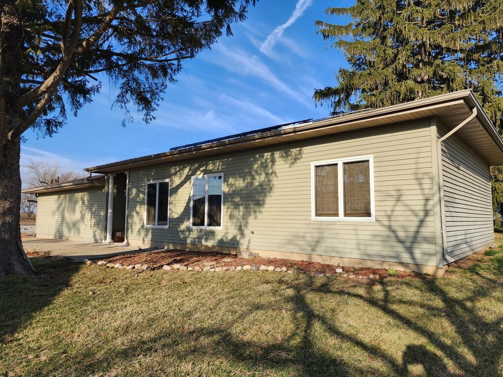 rear view of property with a patio area and a lawn