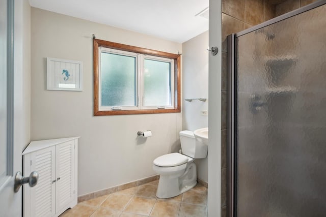 full bathroom with baseboards, tile patterned flooring, toilet, and a shower stall