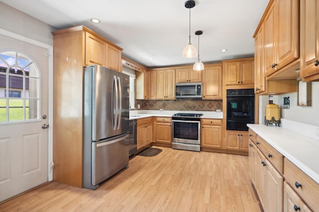 kitchen with light countertops, backsplash, appliances with stainless steel finishes, and a warming drawer