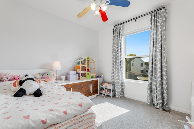 bedroom with light carpet, baseboards, and ceiling fan