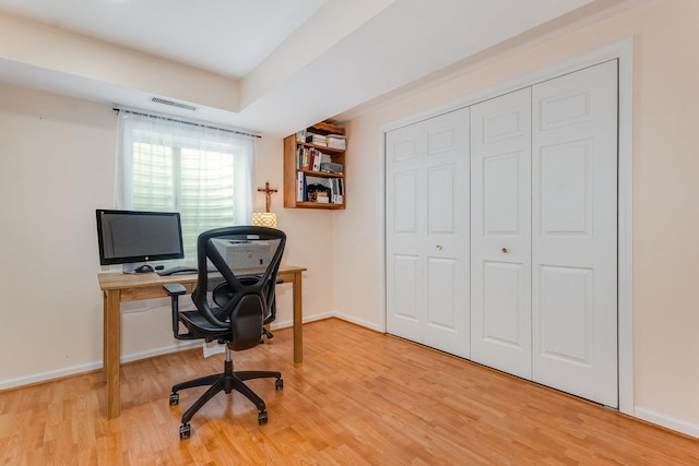 office with visible vents, baseboards, and wood finished floors