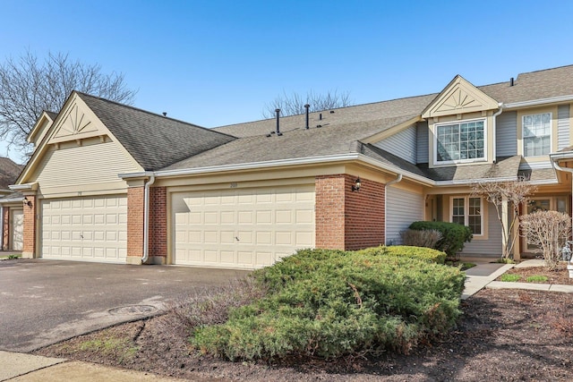 200 Glasgow Ln, Schaumburg, IL 60194 - view of front of house with a garage, asphalt driveway, brick siding, and a shingled roof