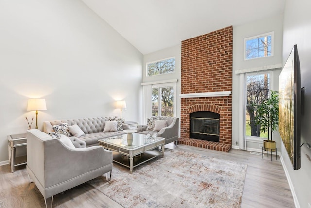 200 Glasgow Ln, Schaumburg, IL 60194 - living area featuring high vaulted ceiling, plenty of natural light, wood finished floors, and a brick fireplace