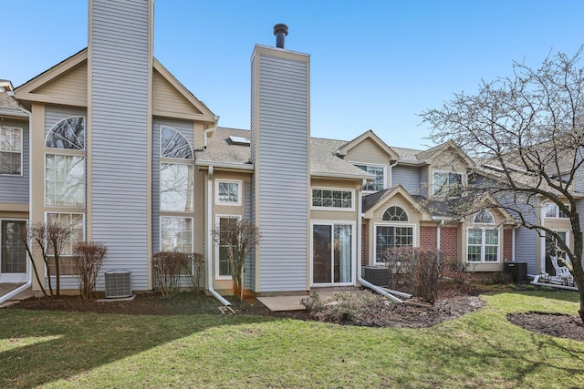 200 Glasgow Ln, Schaumburg, IL 60194 - back of house with a chimney, a lawn, and roof with shingles