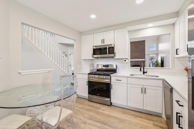 200 Glasgow Ln, Schaumburg, IL 60194 - kitchen featuring appliances with stainless steel finishes, recessed lighting, light countertops, white cabinets, and tasteful backsplash