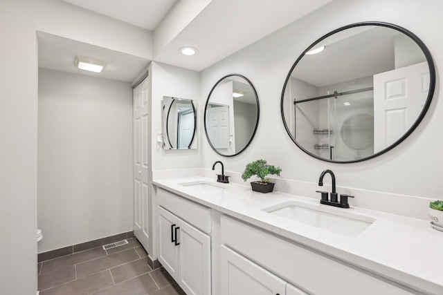 200 Glasgow Ln, Schaumburg, IL 60194 - bathroom featuring double vanity, tile patterned flooring, a shower with shower door, and recessed lighting