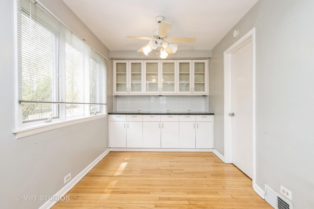 349 Ridge Rd, Kenilworth, IL 60043 - unfurnished dining area with baseboards, ceiling fan, light wood finished floors, and visible vents