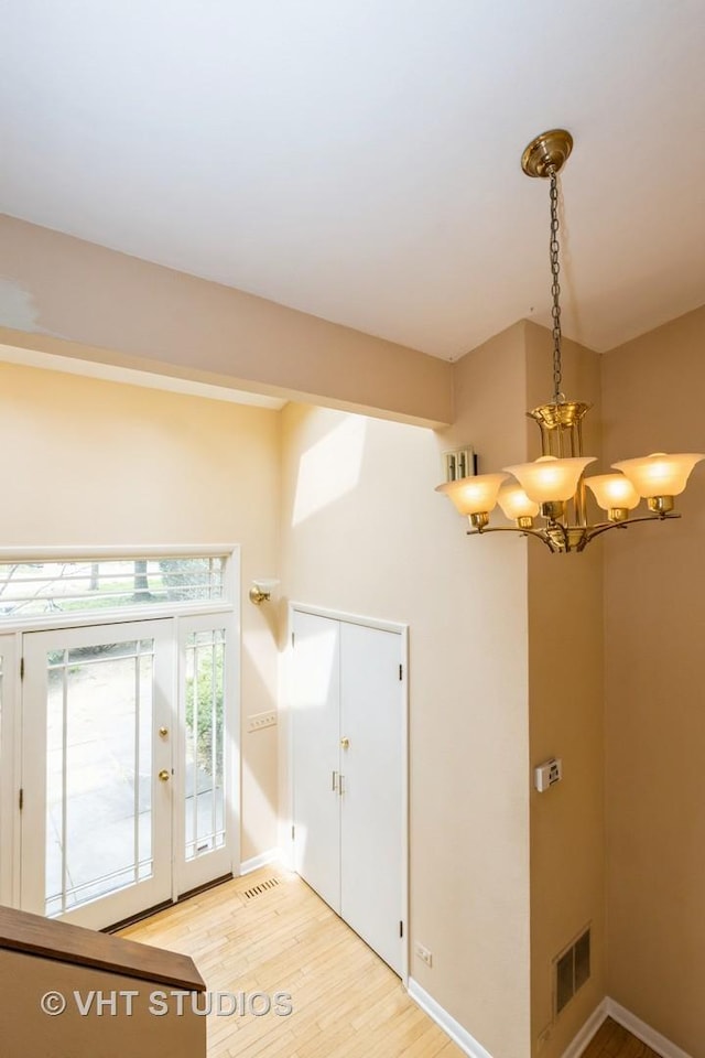 349 Ridge Rd, Kenilworth, IL 60043 - entrance foyer with baseboards, light wood-style floors, an inviting chandelier, and visible vents
