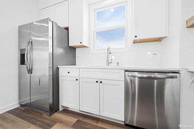 18445 Kedzie Ave, Homewood, IL 60430 - kitchen with appliances with stainless steel finishes, a sink, dark wood-type flooring, and white cabinetry