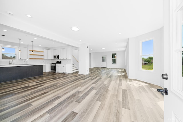 18445 Kedzie Ave, Homewood, IL 60430 - unfurnished living room with a sink, light wood-style floors, stairway, recessed lighting, and baseboards