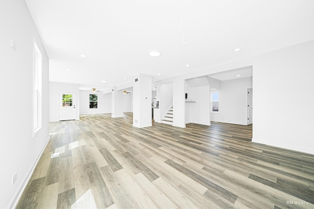 18445 Kedzie Ave, Homewood, IL 60430 - unfurnished living room with stairs, light wood-style floors, baseboards, and recessed lighting