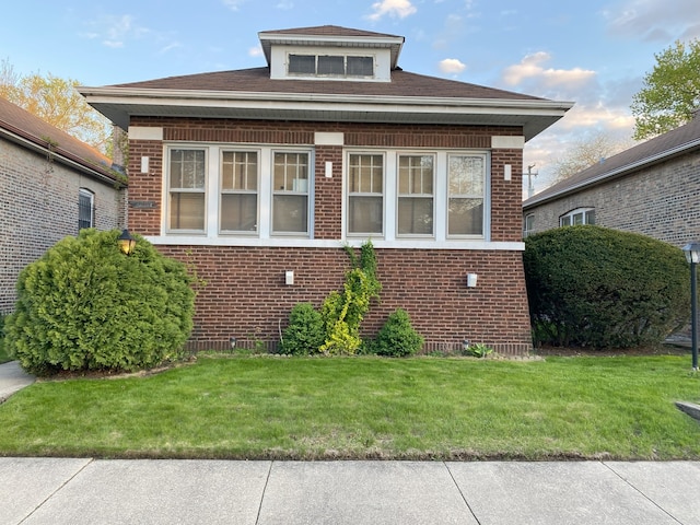 1225 E 71st Pl, Chicago, IL 60619 - bungalow featuring brick siding and a front lawn