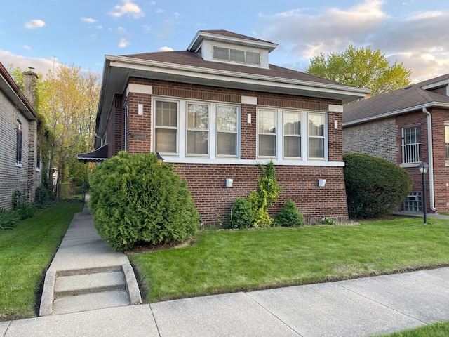 1225 E 71st Pl, Chicago, IL 60619 - bungalow-style house with a front yard and brick siding