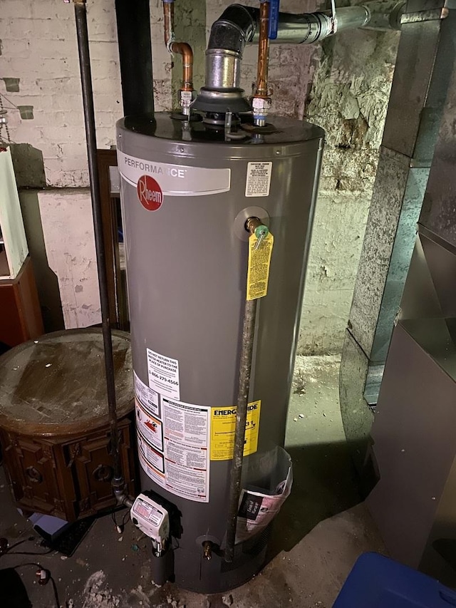 utility room featuring water heater and heating unit