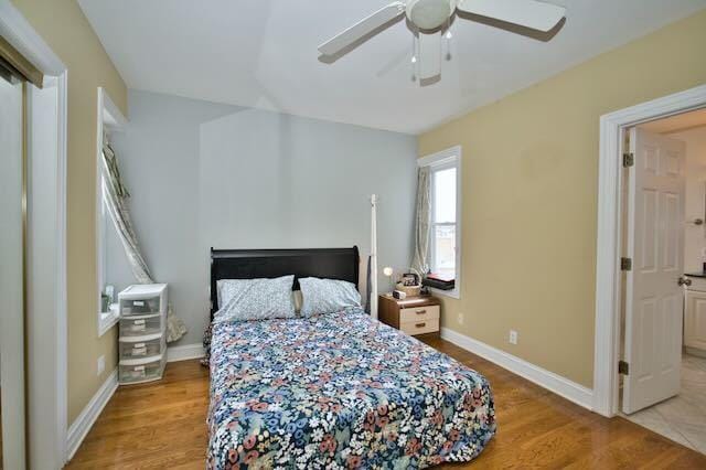 6237 N Mozart St, Chicago, IL 60659 - bedroom featuring baseboards, a ceiling fan, and wood finished floors