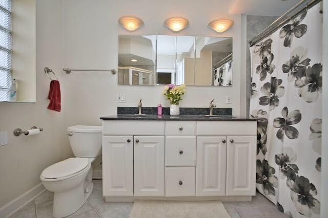 6237 N Mozart St, Chicago, IL 60659 - full bath with toilet, double vanity, a sink, and baseboards