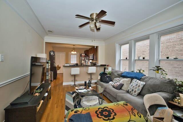 6237 N Mozart St, Chicago, IL 60659 - living room featuring wood finished floors, ceiling fan, and visible vents