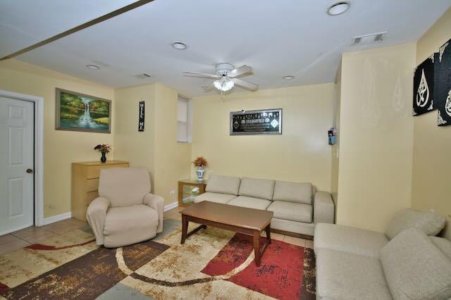 6237 N Mozart St, Chicago, IL 60659 - living area with tile patterned floors, baseboards, a ceiling fan, and visible vents