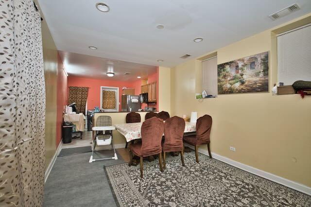6237 N Mozart St, Chicago, IL 60659 - carpeted dining space featuring visible vents, baseboards, and recessed lighting