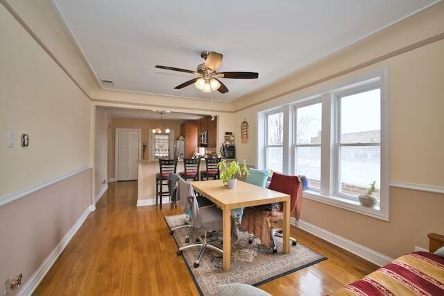 6237 N Mozart St, Chicago, IL 60659 - dining room featuring visible vents, baseboards, a ceiling fan, and wood finished floors