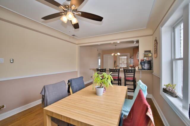 6237 N Mozart St, Chicago, IL 60659 - dining area with baseboards, a ceiling fan, and wood finished floors