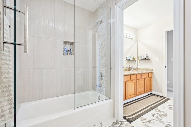 bathroom with marble finish floor, shower / bath combination with glass door, and vanity