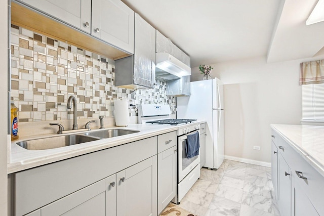 kitchen featuring a sink, white range with gas stovetop, under cabinet range hood, marble finish floor, and decorative backsplash
