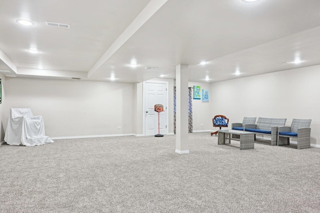 finished basement with baseboards, visible vents, and carpet