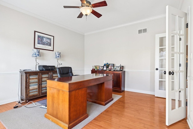 office area with visible vents, ornamental molding, ceiling fan, and light wood-type flooring